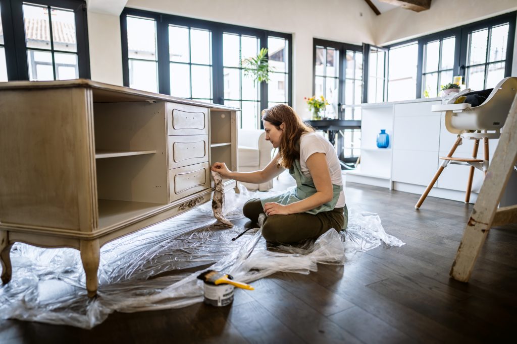 Young Woman Repairing An Old Furniture And Enjoying At Home