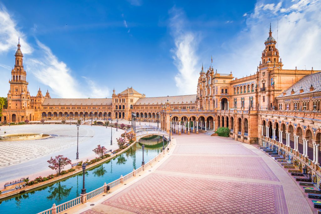 Spain Square In Seville, Spain. A Great Example Of Iberian Renaissance Architecture During A Summer Day With Blue Sky