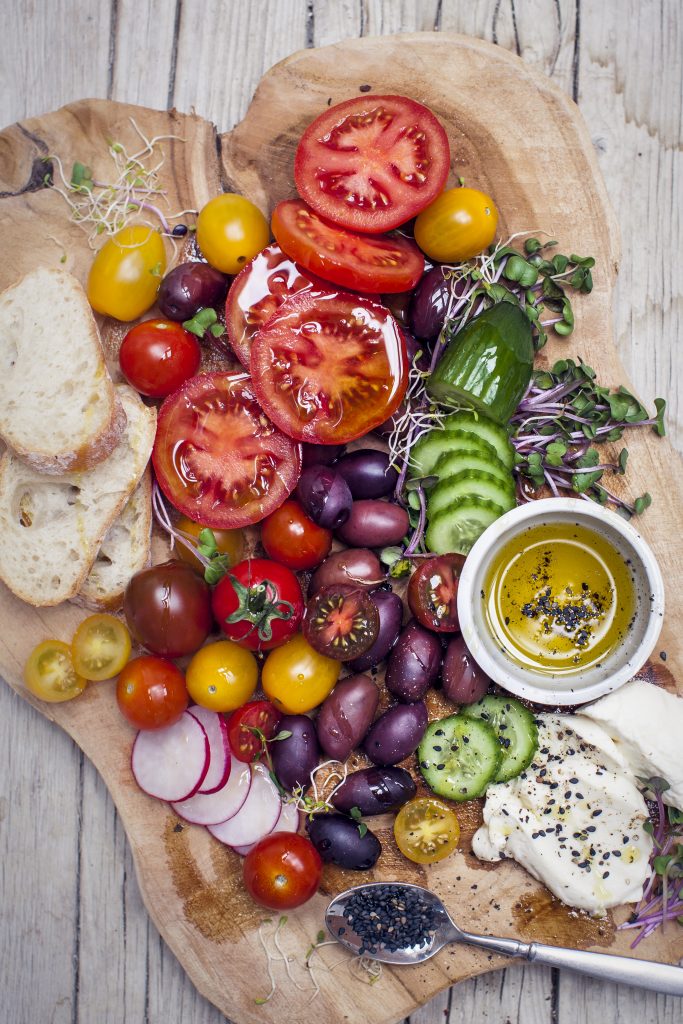 Healthy Snack Of Olives, Tomatoes, Olive Oil, Bread And Cucumber