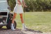 Attractive Golfer Woman Posing In Short Skirt On Course At Golf Car