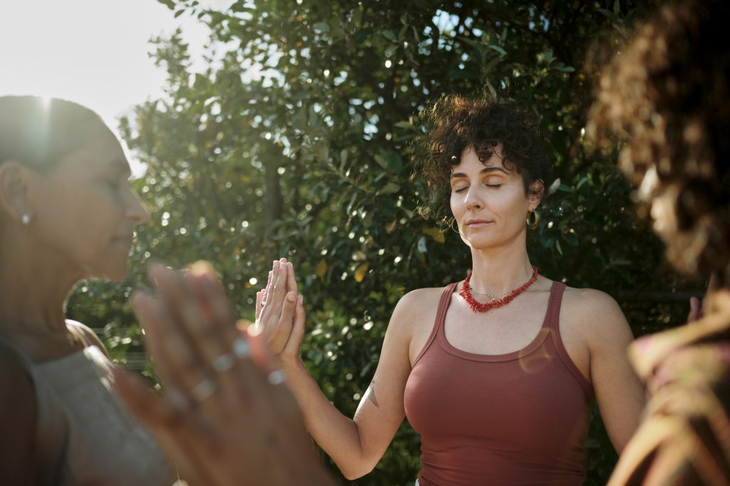 Group Of Women Doing A Wellness Exercise Outdoors During A Retreat