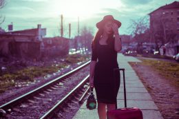 Sensual Woman Pulling Suitcase On The Railroad Station