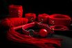 Red Bondage Kit Set On Black Background With Dramatic Light