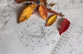 Printed Astrology Charts With Yelow And Autumn Leaves In The Background