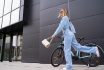 Fashion Portrait Of Beautiful Trendy Girl In Motion Next To New Bicycle