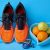 Orange Sneakers, Glucometer, Bottle Of Drinking Water And Fruits On Blue Background