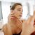 Close Up Of A Young Woman Looking At Pimples In The Mirror.