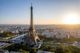 Aerial View Of Paris, France, Overlooking The Famous Eiffel Tower, Sunrise In The Background.