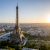 Aerial View Of Paris, France, Overlooking The Famous Eiffel Tower, Sunrise In The Background.