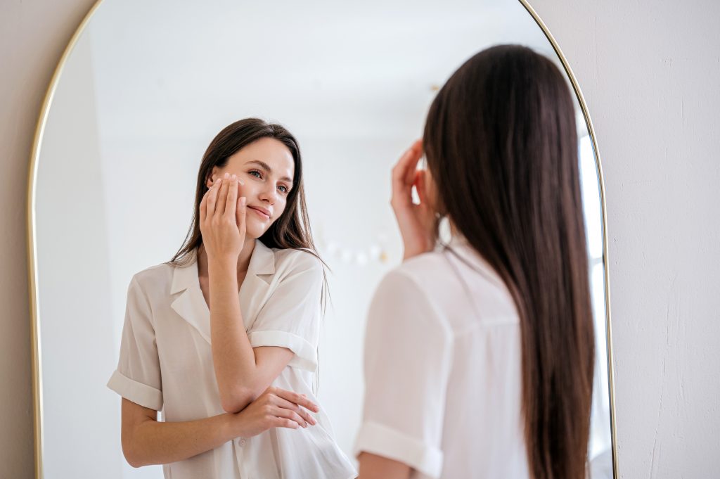 Woman Applying Moisturizing Nourishing Cream With Collagen On Dry Skin Under Eyes