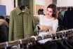 Woman Choosing Green Quilted Jacket In Womenâs Cloths Store