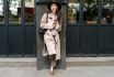 Beautiful Young Brunette Woman Wearing A Beige Coat In Autumn City. Outdoor Fashion Portrait Of Glamour Young Chinese Cheerful Stylish Lady In Street. Emotions, People, Beauty And Lifestyle Concept.