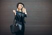 Street Portrait Of Glamour Sensual Young Stylish Lady Wearing Trendy Fall Outfit. Blonde Woman In Black Hat And Leather Jacket And Bag.