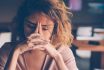 Tired Young Woman Leaning Head On Hands