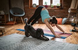 Woman Doing Yoga With Her Dog