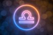 Glowing Neon Sign Of Libra With Blurred Bokeh Background. 3d Illustration