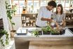 Multi Ethnic Couple Taking Care Of Kitchen Herbs