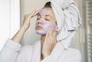 Portrait Of Young Beautiful Woman With A Facial Mask Having A Spa Treatment At Home