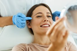 Beautiful Woman On Facial Treatment Looking At Mirror