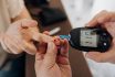 Nurse Measuring Patient's Glucose At Home