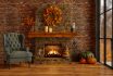 Chalet With Halloween Decoration. Living Room Interior With Pumpkins, Armchair And Fireplace