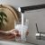 Woman Filling Glass With Tap Water From Faucet In Kitchen, Closeup