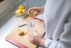 Woman Squeezing Out Juice Of Lemon