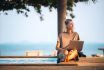 A Woman Works Remotely By The Pool