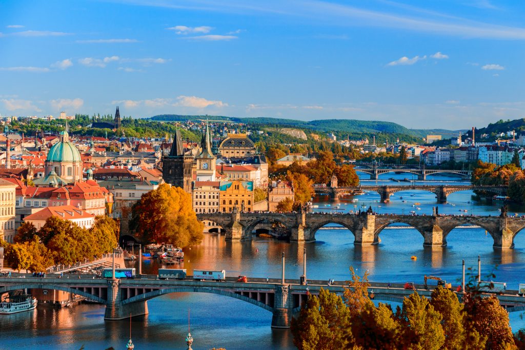 Vltava River And Charle Bridge With Red Foliage