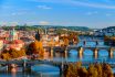 Vltava River And Charle Bridge With Red Foliage