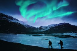 Hikers Under The Northern Lights