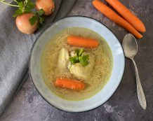 Healthy Hungarian Chicken Soup. The Soup Is A Golden Broth Slow Simmered With Chicken And A Solid Line Up Of Root Vegetables – Red And Yellow Carrots, Celery, Onions, Parsley, Peter Root, Leek, Salt And Peppercorns. Served With Noodles.