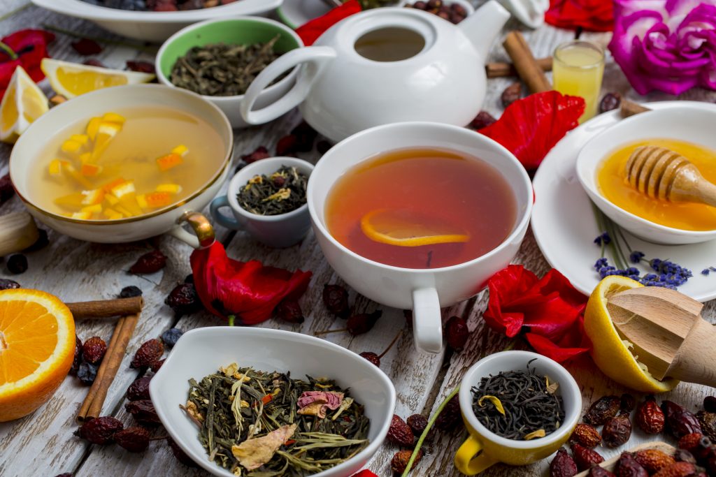 Various Leaves Of Tea And Spices On Wooden Background