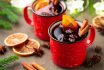 Two Cups Of Christmas Mulled Wine Or Gluhwein With Spices And Orange Slices On Rustic Table Top View. Traditional Drink On Winter Holiday