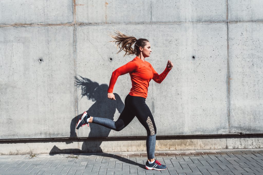 Woman Running Outdoors In The City