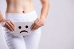 Closeup Young Woman Holding Paper With Sad Smiley Face Or Unhappy Near Her Crotch Lower Abdomen. Medical Or Gynecological Problems, Healthcare Concept.