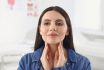 Endocrine System. Young Woman Doing Thyroid Self Examination Indoors