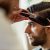 Young Man Having A Haircut At Barber Shop.