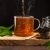 Cup Of Green Tea And Dry Loose Leaves, Dark Moody Background