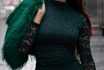 Fashion Model Wearing Emerald Green Lace Dress And Faux Fur Stole Walks Down City Street