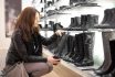 Young Lady Looking At Boots In A Boutique