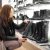 Young Lady Looking At Boots In A Boutique