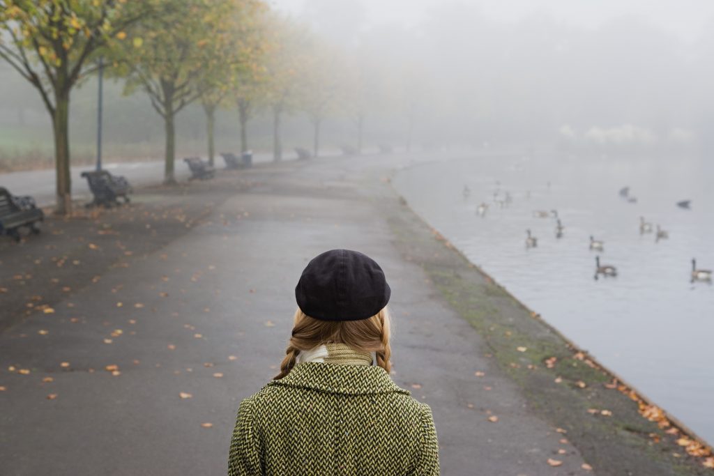 Woman Walking Through Park