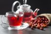 Dried Rose Hip Glass Cup Of Herbal Tea Medicinal Plants With Rosehip Fruits In Burlap Sack And Glass Teapot On Black Rustic Table