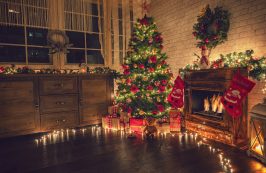 Decorated Christmas Tree Near Fireplace At Home