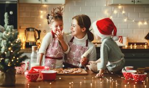 Happy Family Mother And Children Bake Christmas Cookies