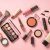 Make Up Products At Pink Background Top View.