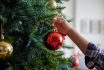 Boy Decorating The Christmas Tree