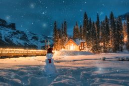 Emerald Lake With Wooden Cottage And Snowman In Falling Snow At Yoho National Park, Canada