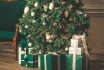 Close Up Of Christmas Tree And Gift Box On Floor At Home